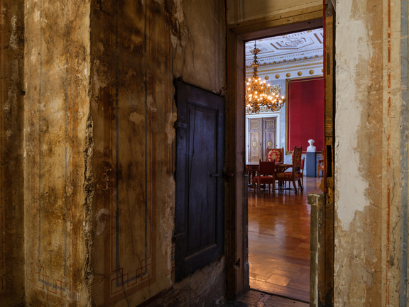 An open room door with a view of a magnificent hall