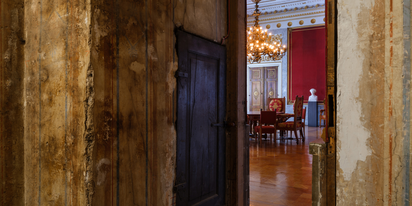 An open room door with a view of a magnificent hall