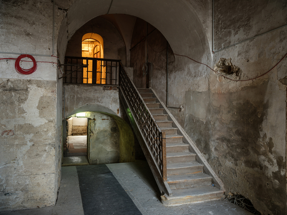 A staircase in bare castle walls