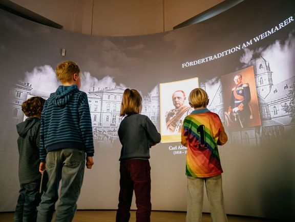 Kinder stehen vor einer Leinwand