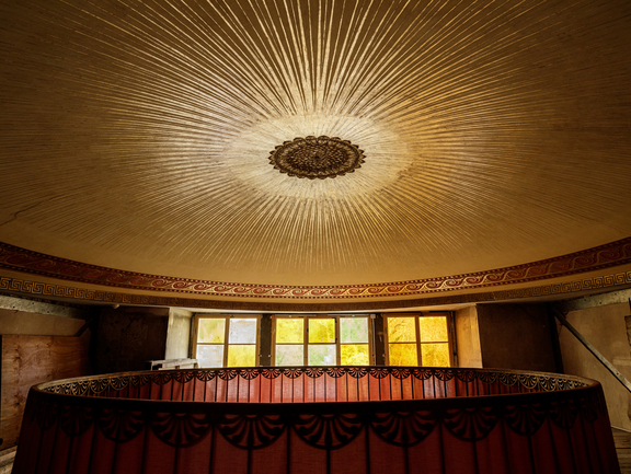 Large round gold ornament on a room ceiling