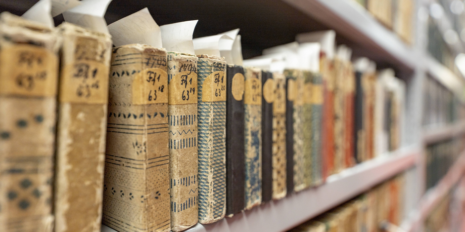 Regalbrett mit Almanachen aus der Sammlung Goldschmidt, mit Einbänden aus Buntpapier 