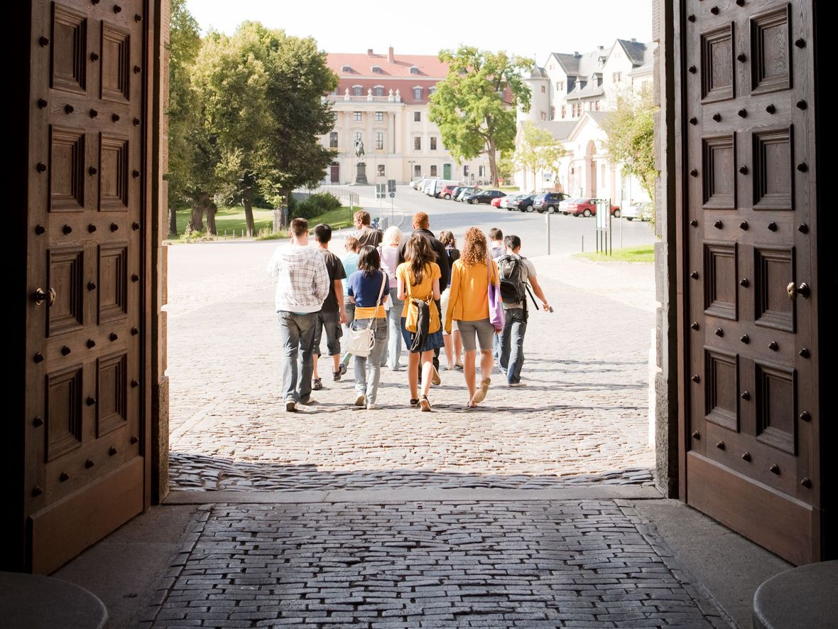A group of young adults leaving the Castle through the main gates