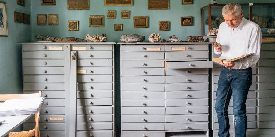 Ein Mitarbeiter der Klassik Stiftung Weimar studiert eine Gesteinsprobe.