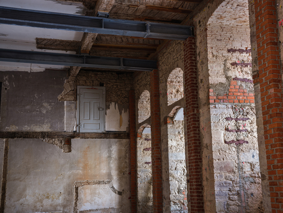View of a stone vault with steel girders and a small door