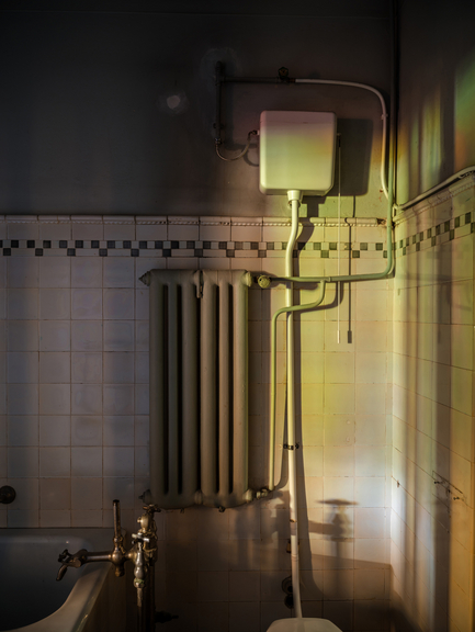 Old bathroom with toilet, heater and bathtub